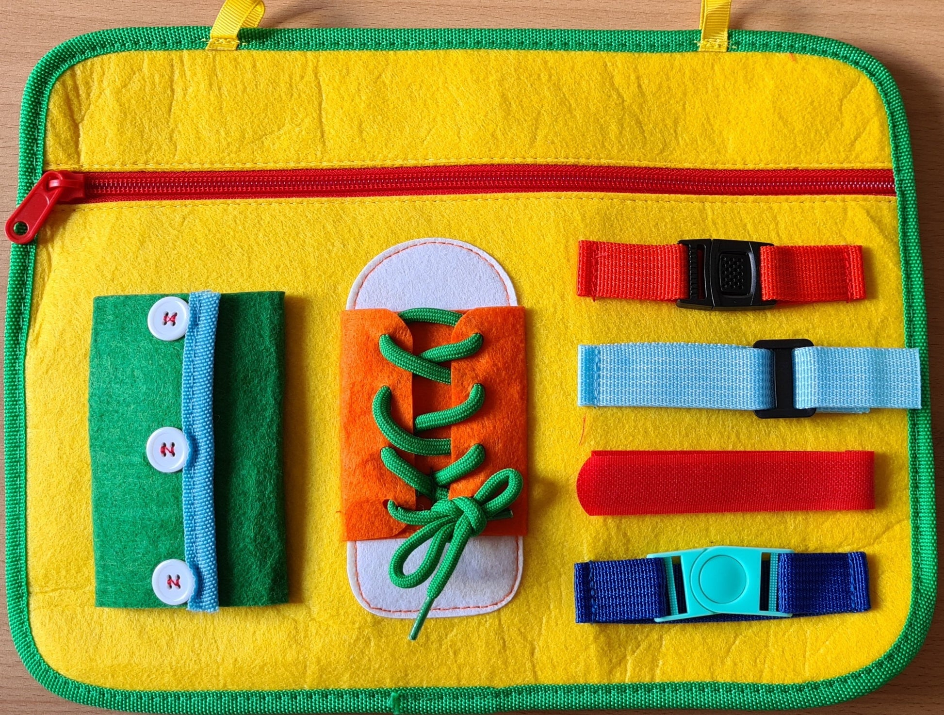 Zip pocket, shoe lace, buttons and buckle activity